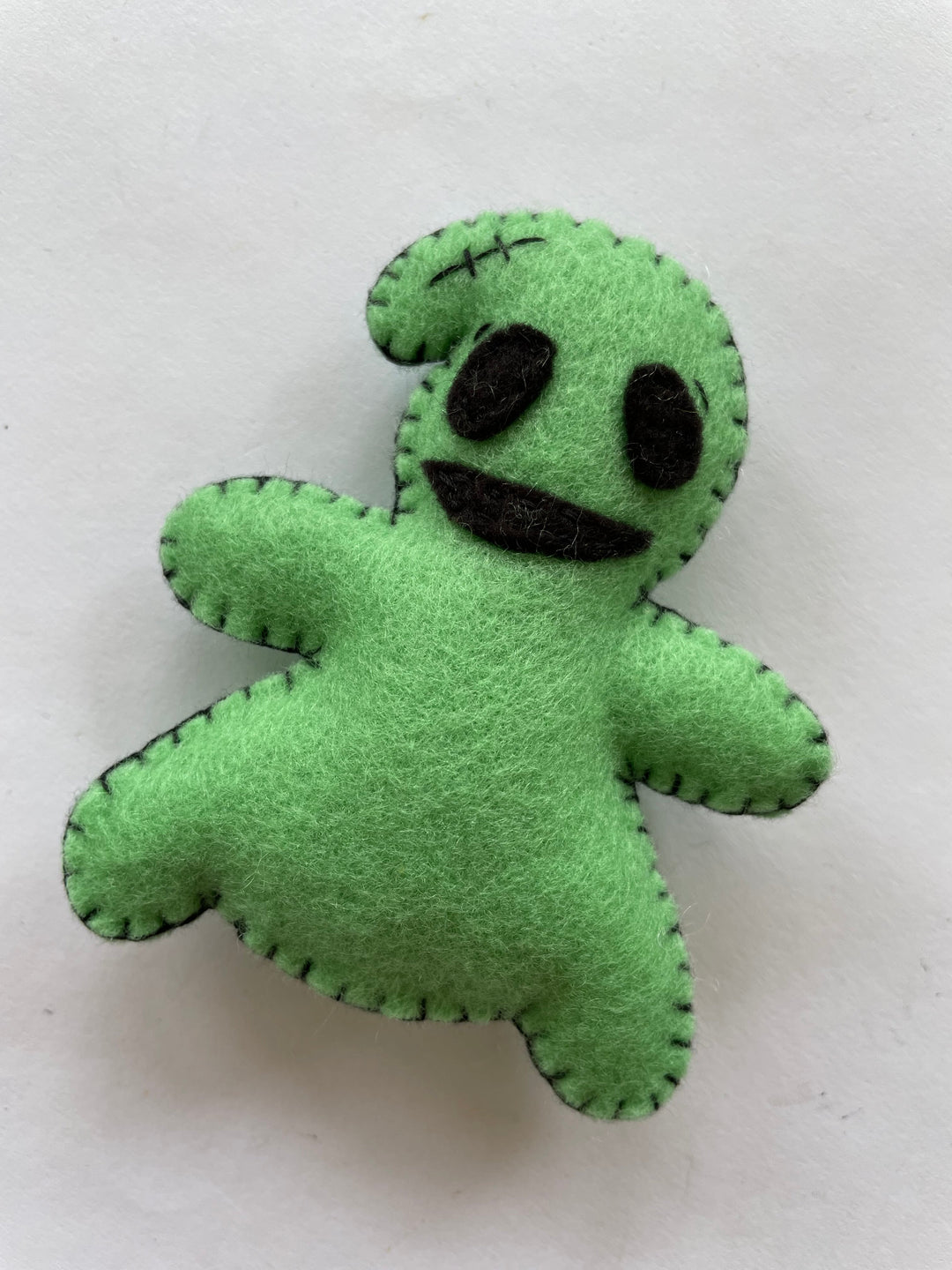 DIY felt Oogie Boogie Halloween decoration made from green FabricLA felt, perfect for spooky crafts and handmade holiday decor.