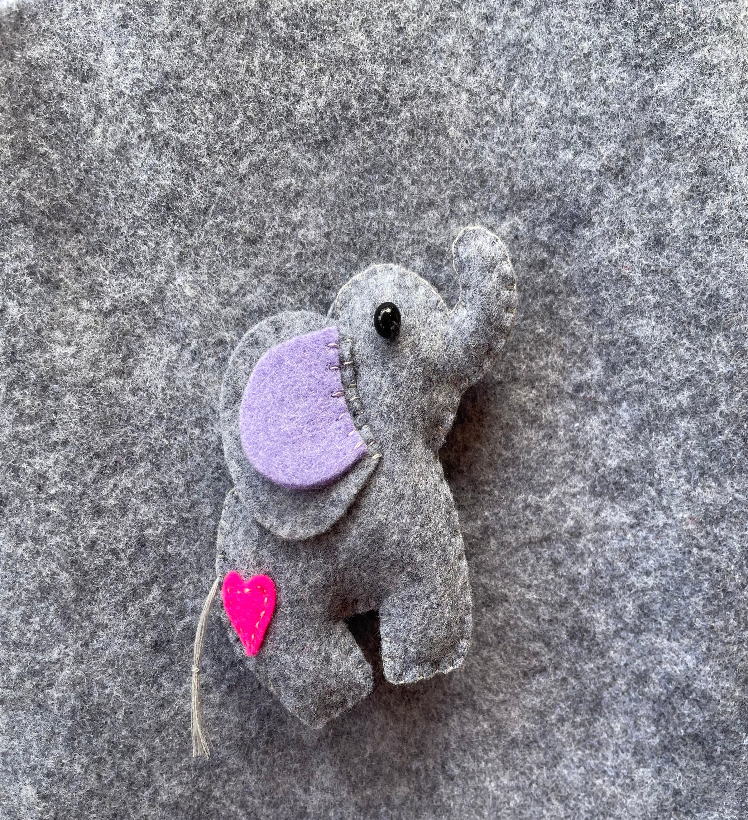 Adorable handmade felt whale crafted from soft blue and white felt, displayed on a light marbled background — a perfect beginner-friendly sewing project from FabricLA’s DIY kit collection.”