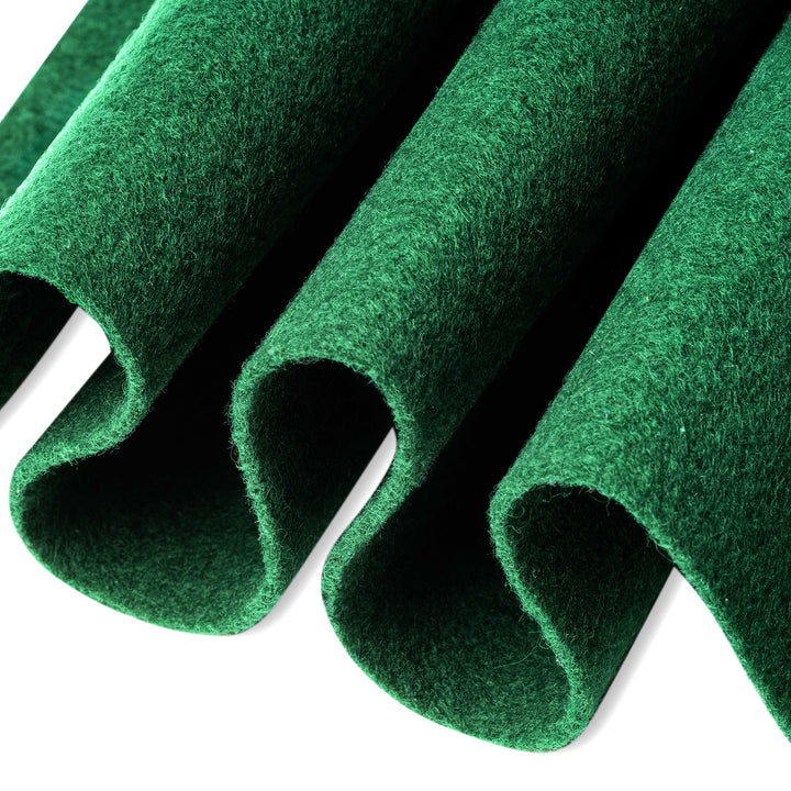 Green felt rolls on a white background
