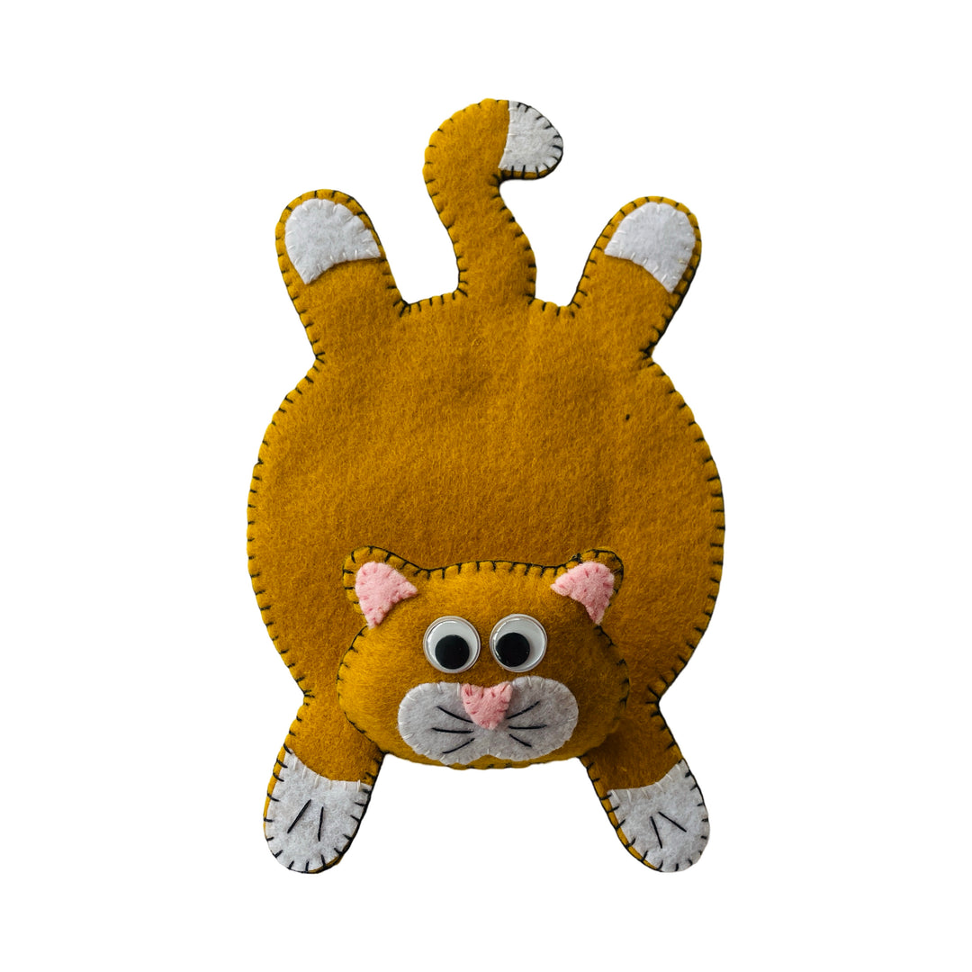 A DIY felt coaster kit shaped like a cat, made from brown felt with white and pink details on a white background.