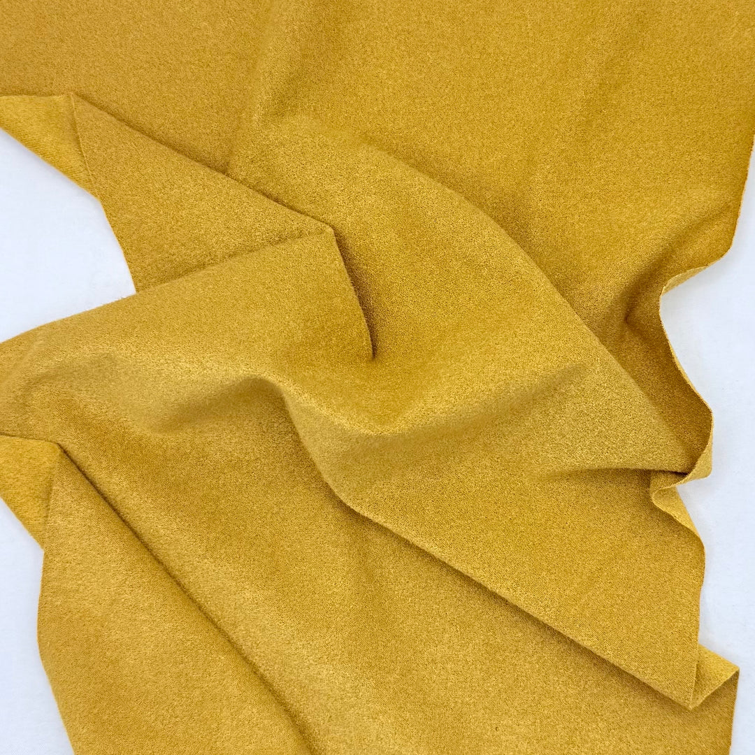 Mustard yellow fabric on a white background