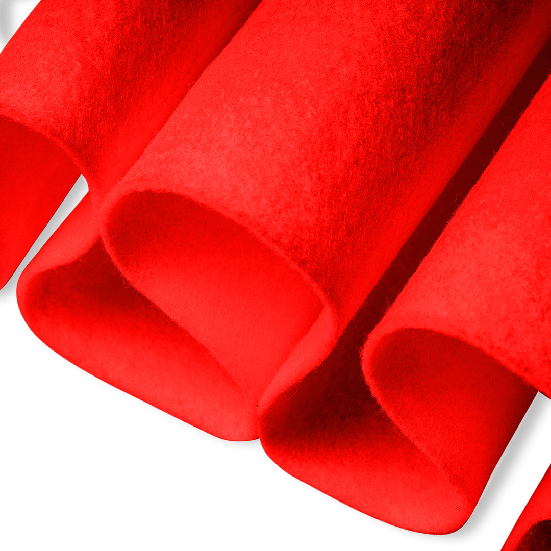 Close-up of neon orange textured fabric with a white background