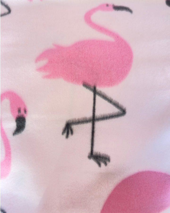 Close-up of pink flamingo pattern on a fabric surface