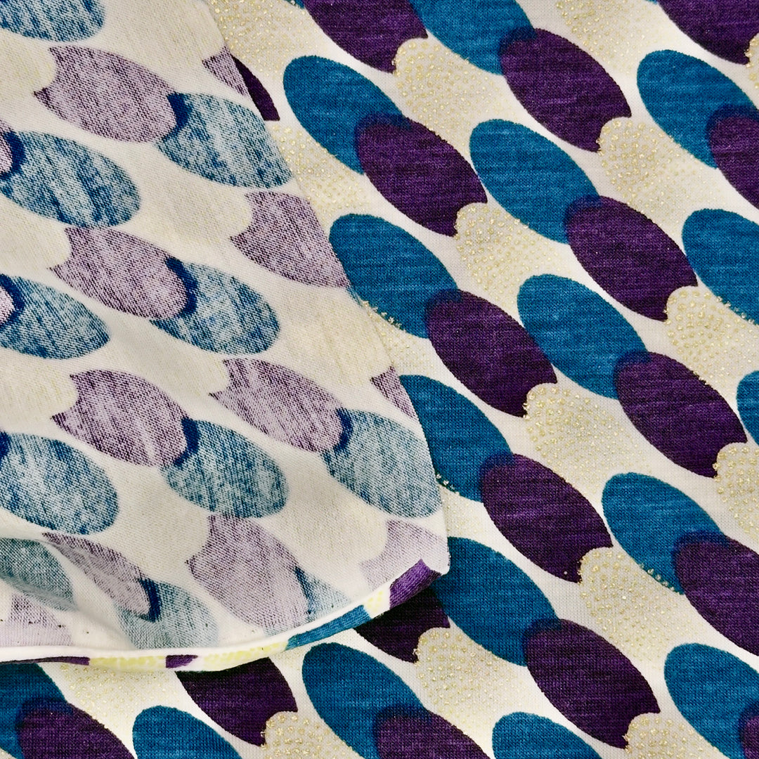 Textile with blue and purple leaf pattern on a beige background
