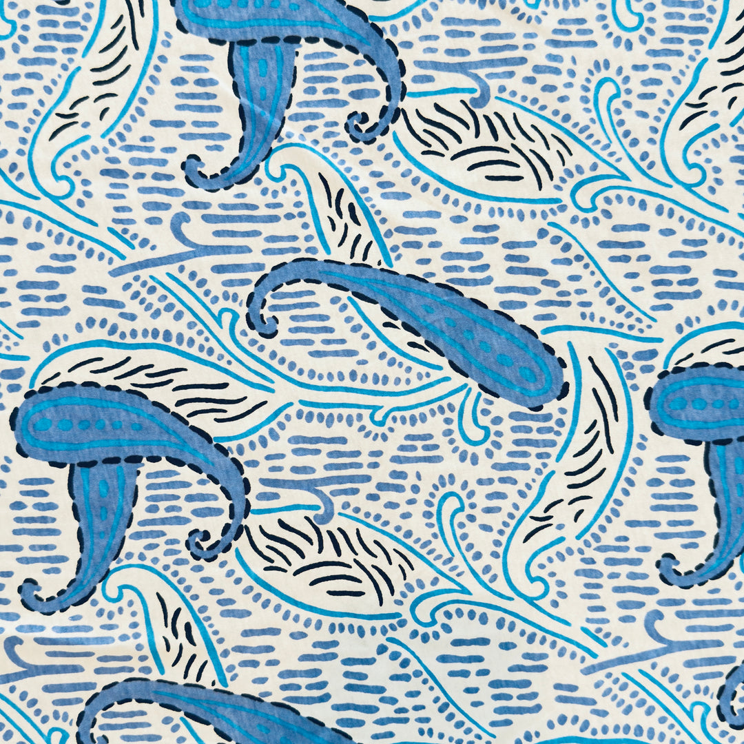 Blue abstract paisley cotton jersey knit fabric, 58–60 inch wide, 130 GSM.