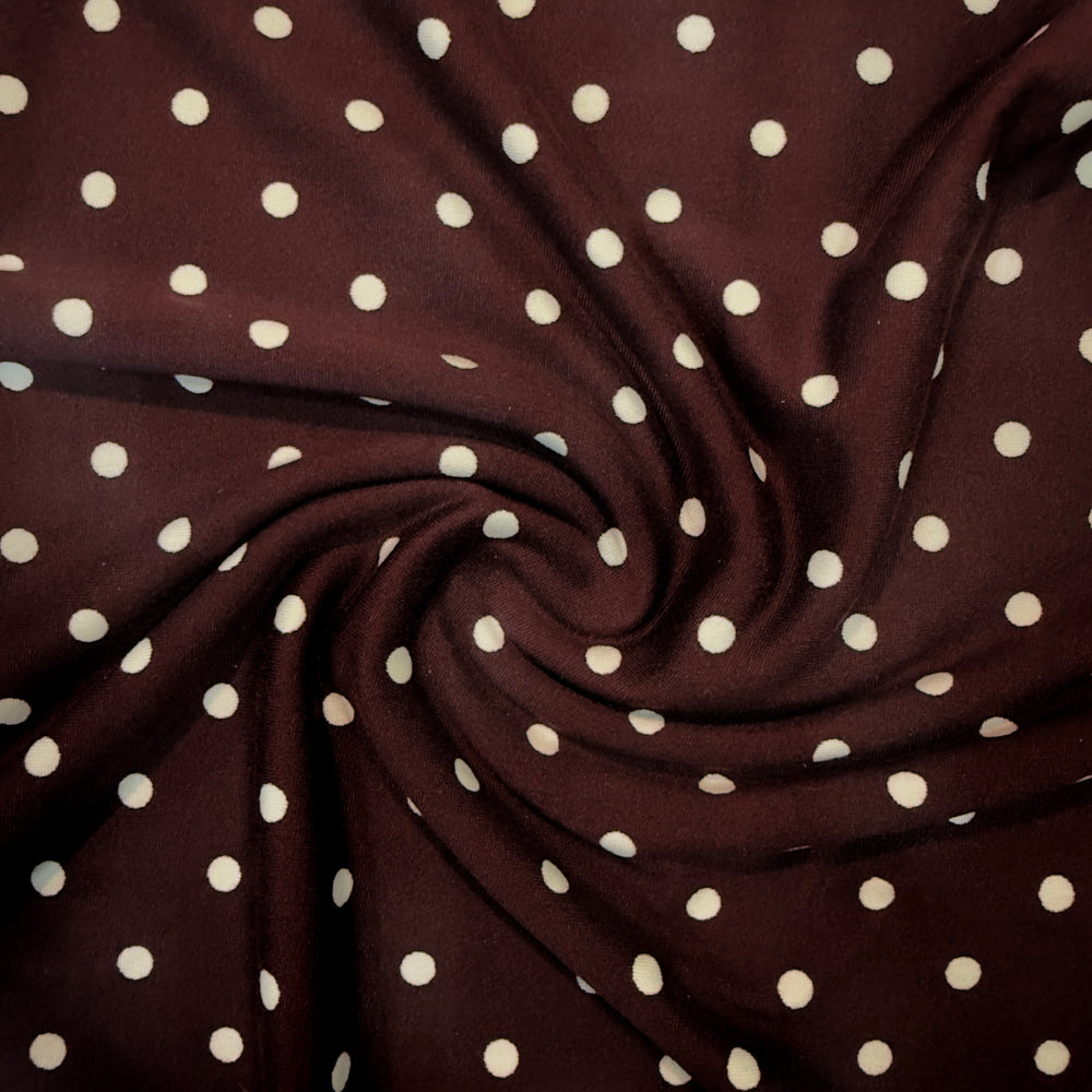 DTY polka dot stretch fabric in burgundy and cream colors, showcasing a soft, 4-way stretch texture.