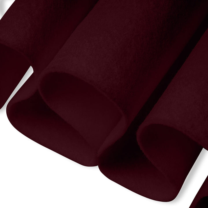 Close-up of dark red fabric with a white background
