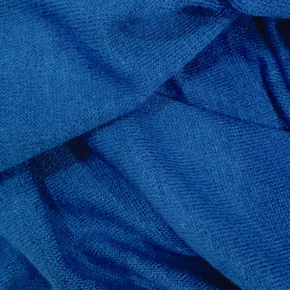 Close-up view of soft cashmere fabric by the yard in a rich blue color, showcasing its smooth texture and luxurious feel.