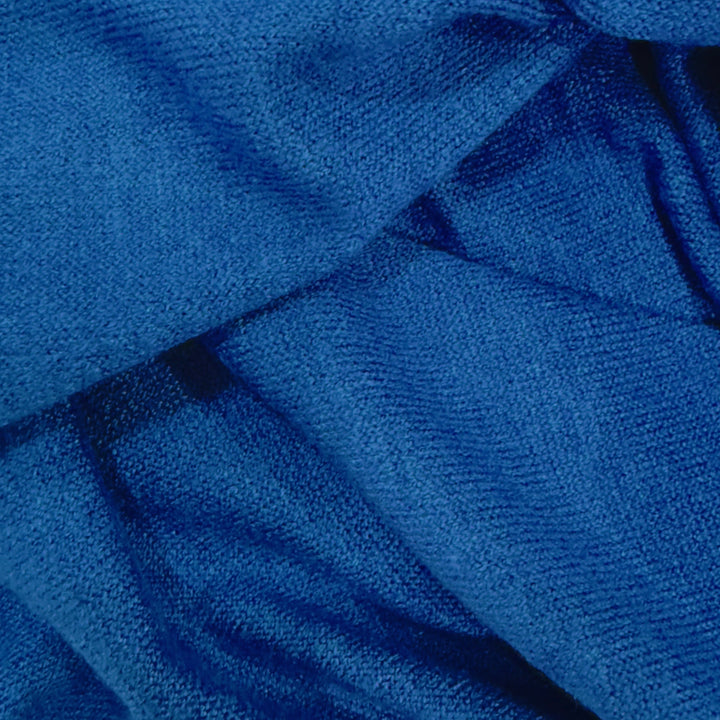 Close-up view of soft cashmere fabric by the yard in a rich blue color, showcasing its smooth texture and luxurious feel.