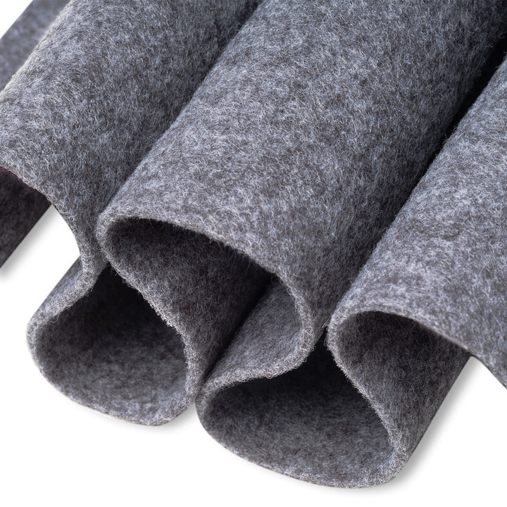 Close-up of gray felt rolls on a white background