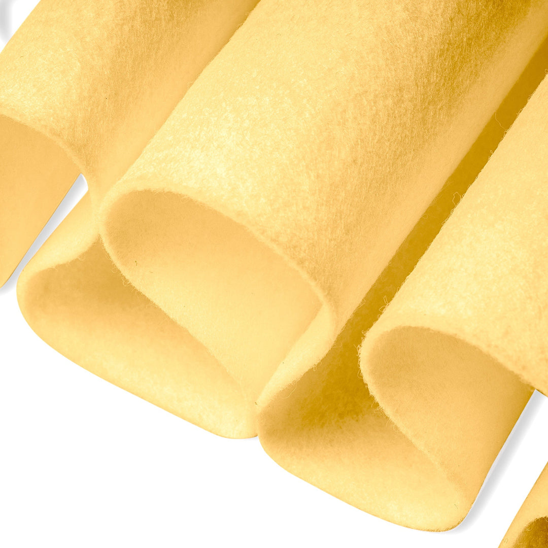 Close-up of yellow pasta on a white background