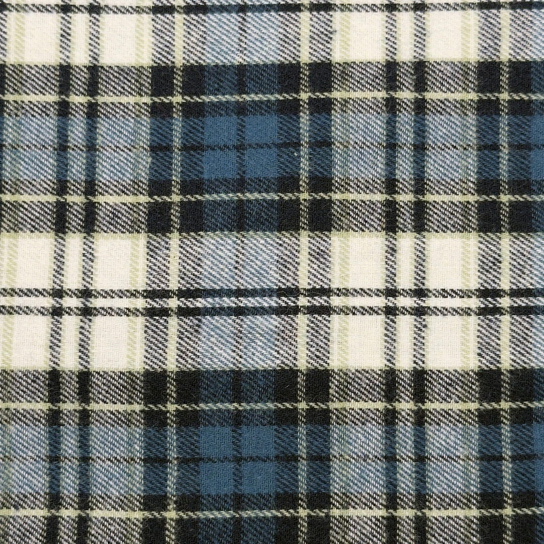 Close-up of a plaid fabric with navy, white, and blue patterns.
