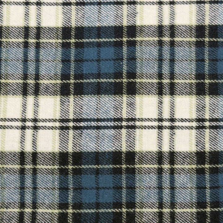 Close-up of a plaid fabric with navy, white, and blue patterns.