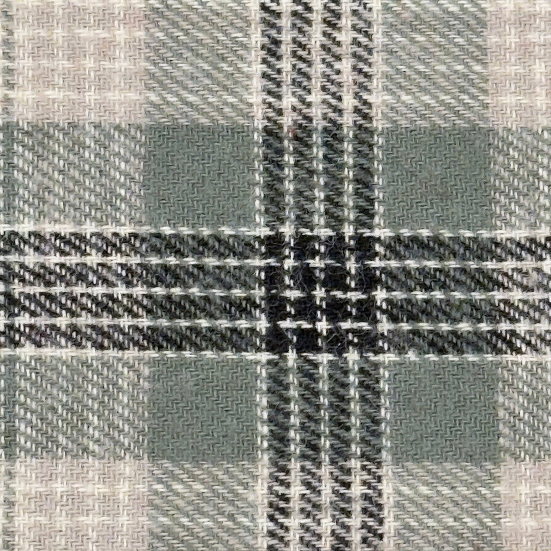 Close-up of a fabric with a plaid pattern in sage, black, gray and white.