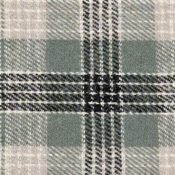 Close-up of a fabric with a plaid pattern in sage, black, gray and white.