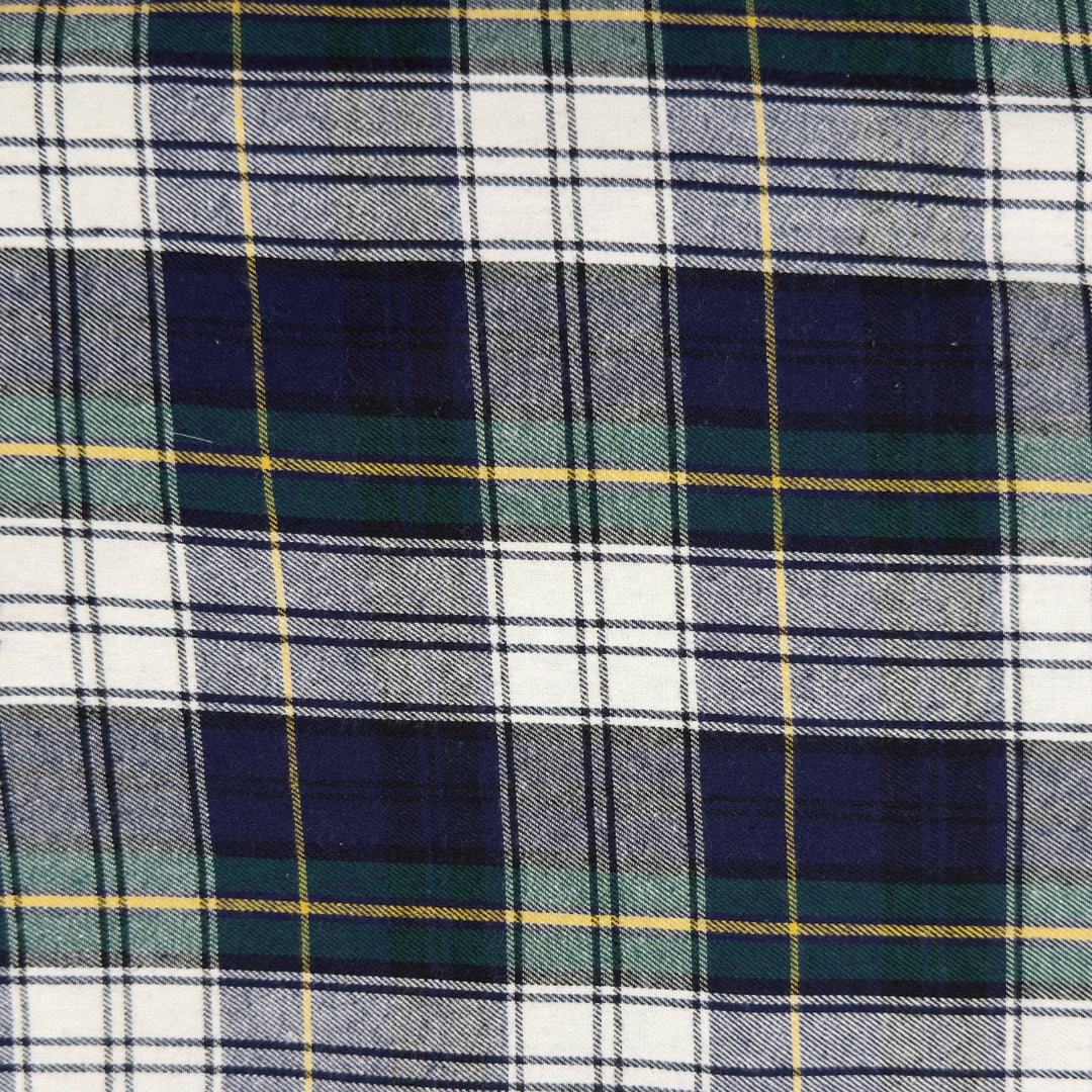 Close-up of plaid fabric with blue, green, and white colors.