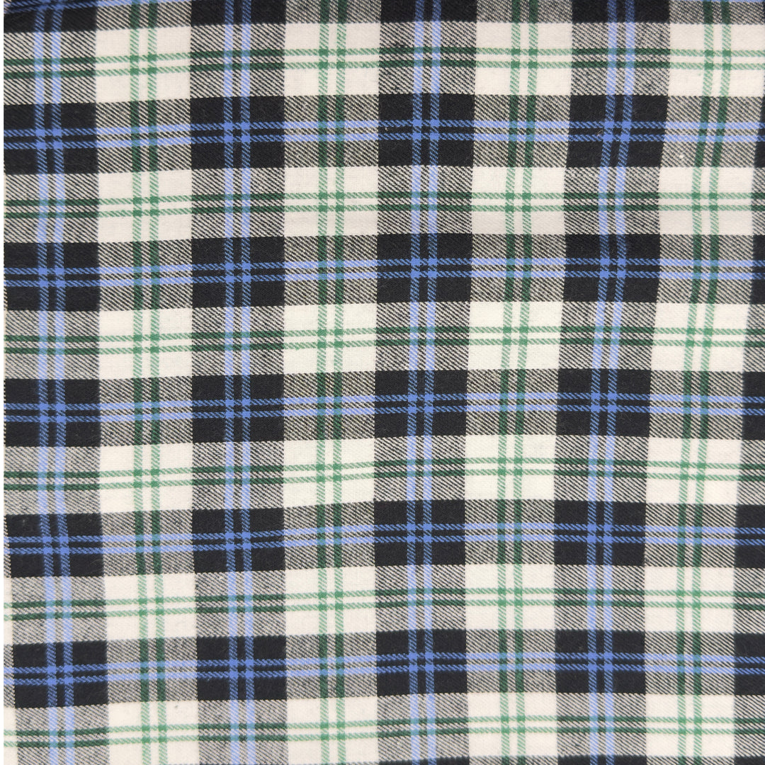 Close-up of a plaid fabric with black, blue, and green pattern.