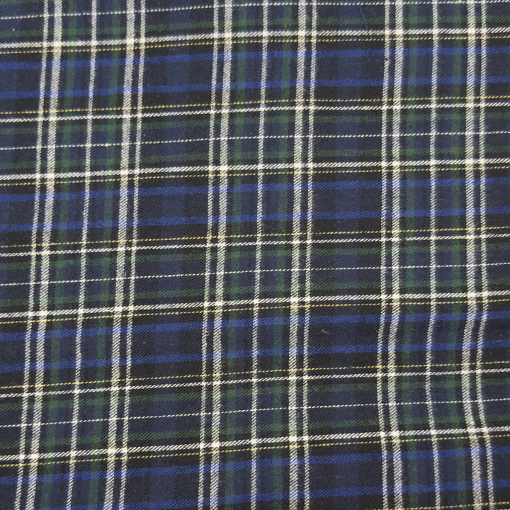Cotton Flannel Fabric in Style 28 with a plaid design featuring blue, green, and white colors. 100% Cotton Soft Fabric.