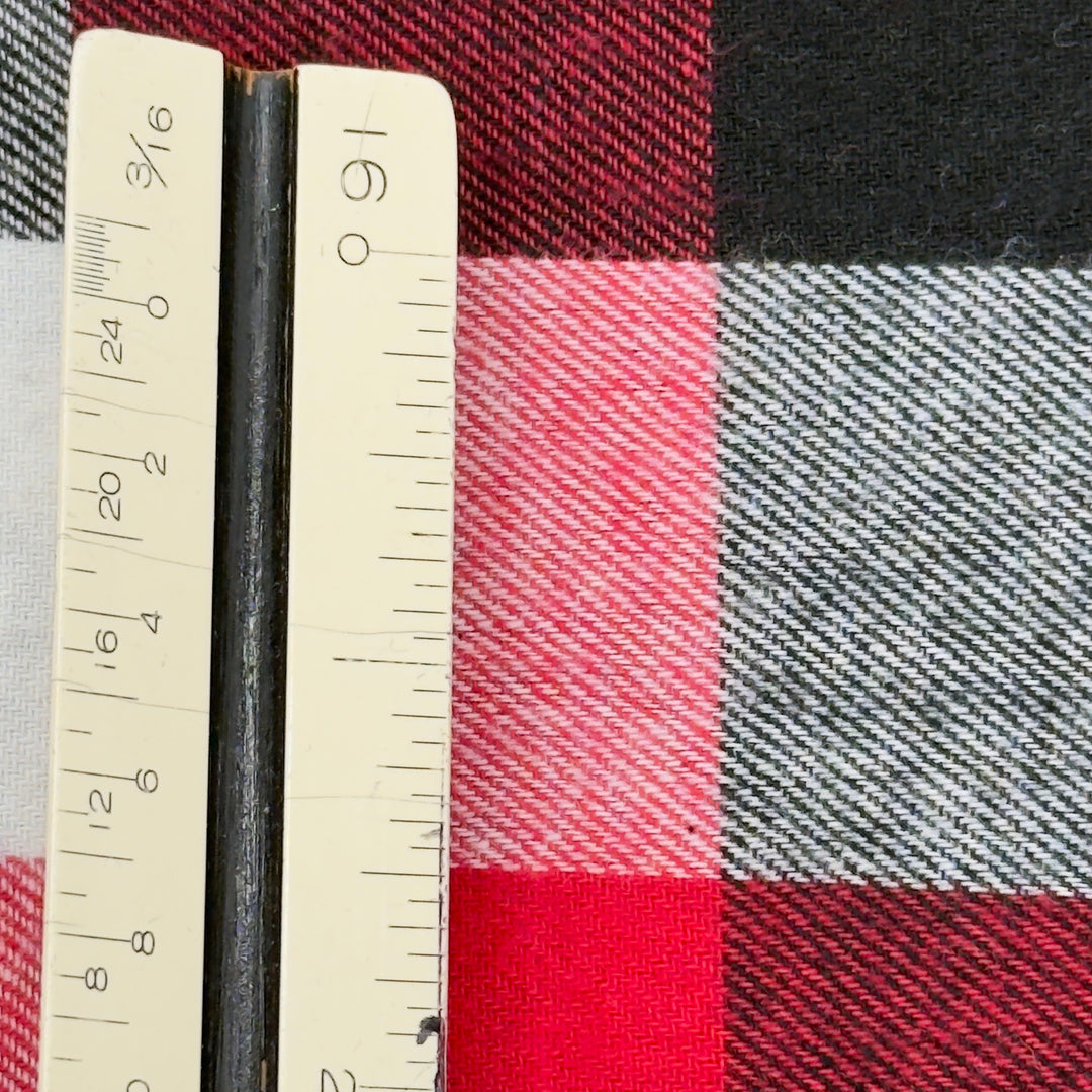 Plaid fabric with a ruler showing measurements on a checkered pattern