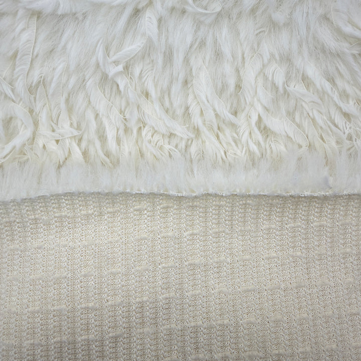 Feather mink faux fur fabric in off white, showcasing luxurious texture and softness for crafting projects.