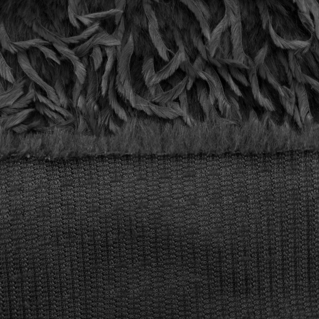Close-up of feather mink faux fur fabric showing soft black texture and plush strands for sewing projects.