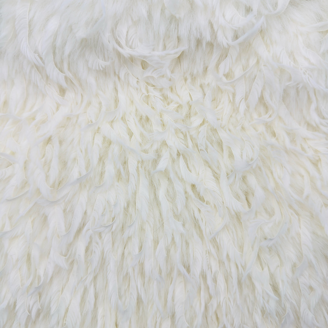 Close-up of feather mink faux fur fabric in off white, showcasing its soft, plush texture and luxurious appearance.