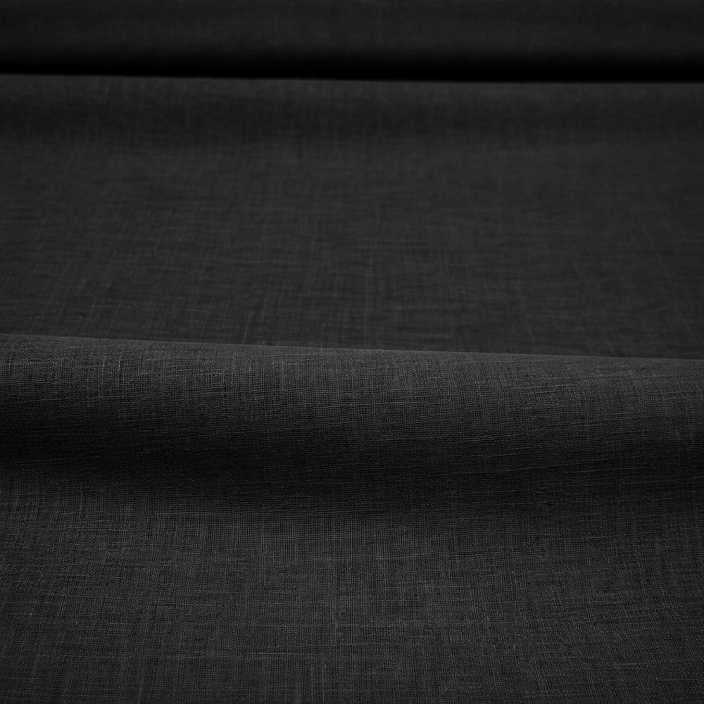 Black cotton lawn fabric close-up showing lightweight smooth wave texture