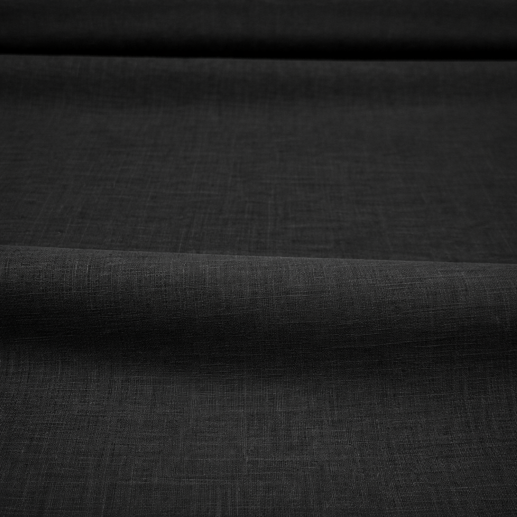 Black cotton lawn fabric close-up showing lightweight smooth wave texture