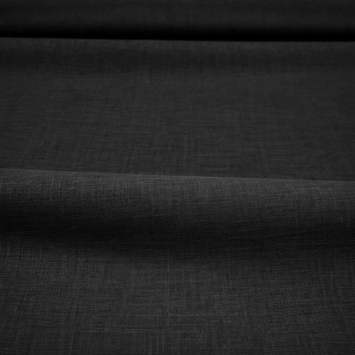 Black cotton lawn fabric close-up showing lightweight smooth wave texture