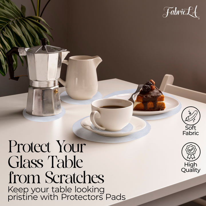 Table setting with coffee maker, cup, and cake on a glass table with text about protectors pads.