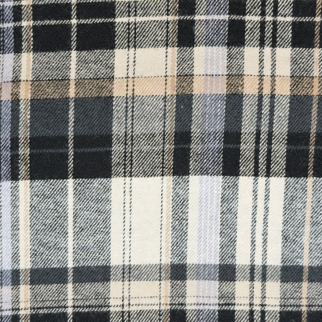 Close-up of a plaid fabric with black, white, and beige colors.