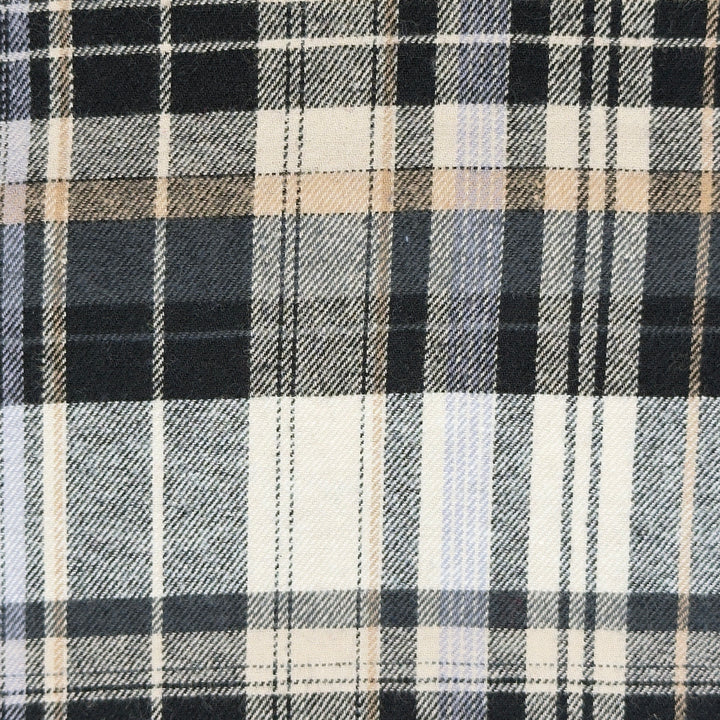 Close-up of a plaid fabric with black, white, and beige colors.