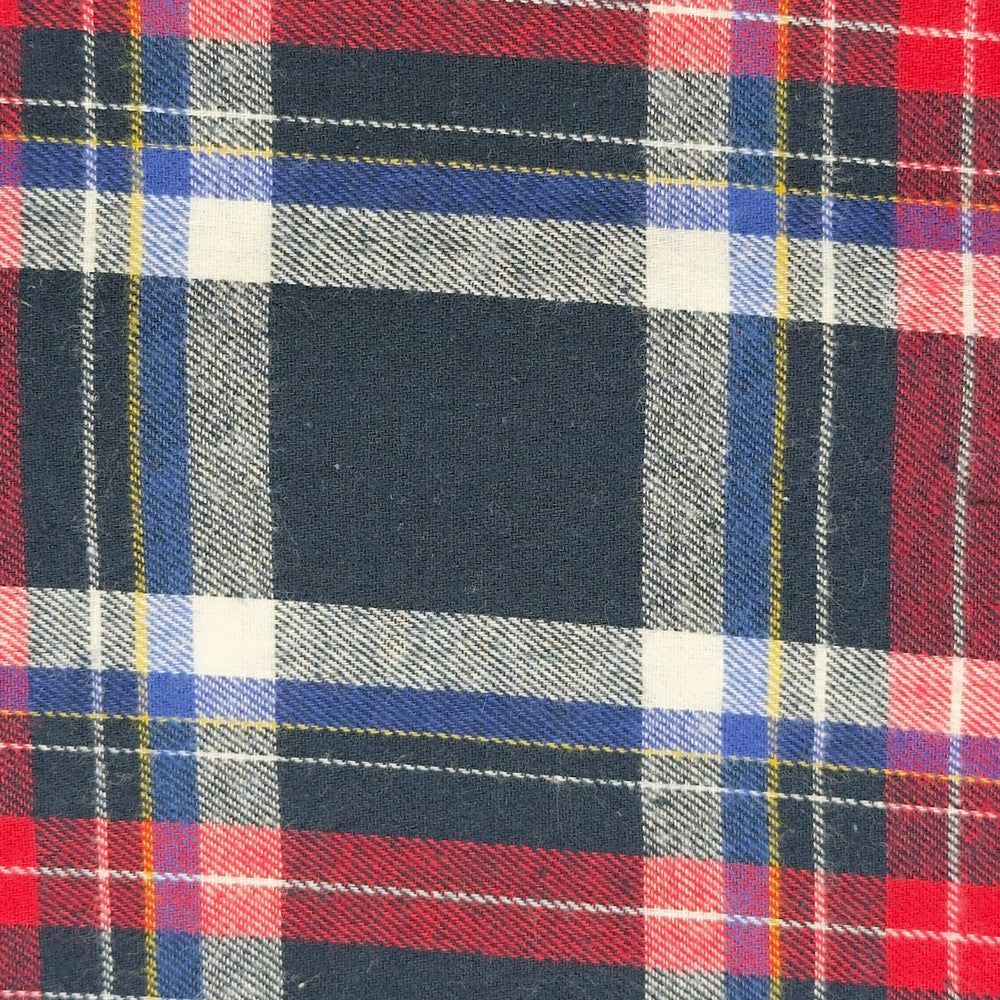 Close-up of a plaid fabric with red, blue, and black patterns.