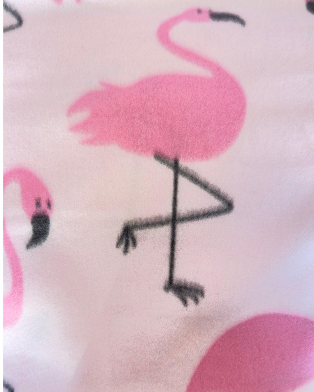 Close-up of pink flamingo pattern on a fabric surface