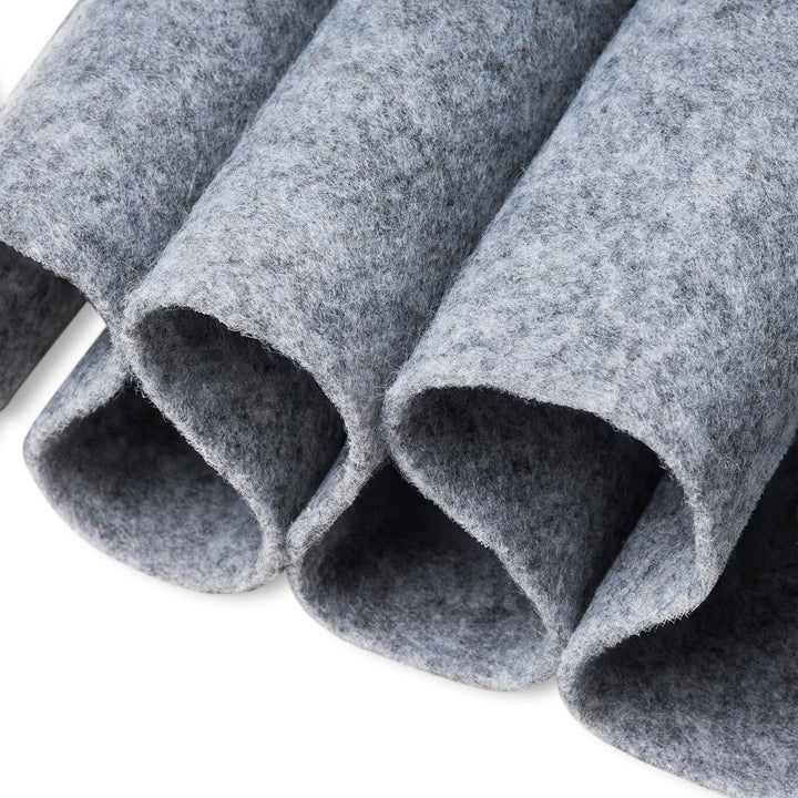 Close-up of gray felt rolls on a white background