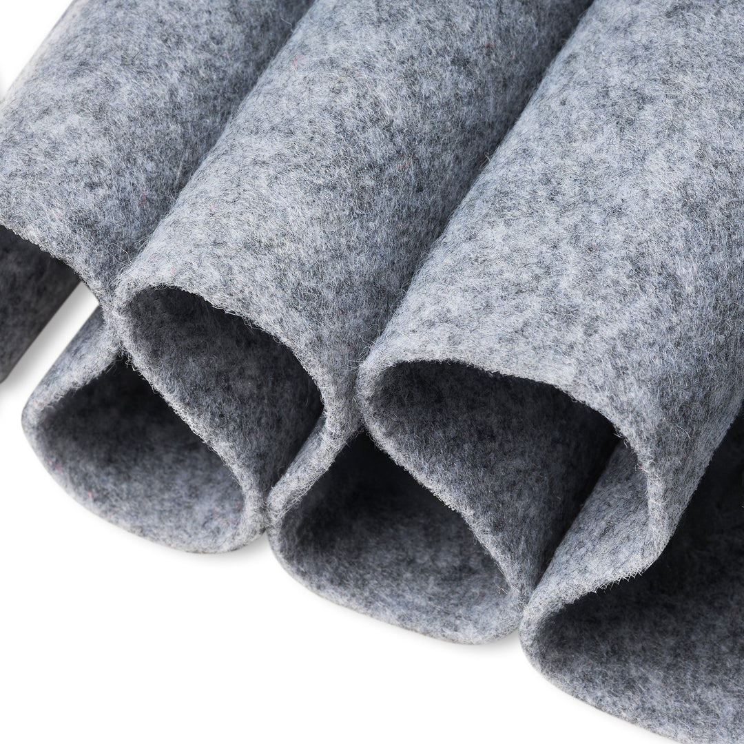 Close-up of gray felt rolls on a white background