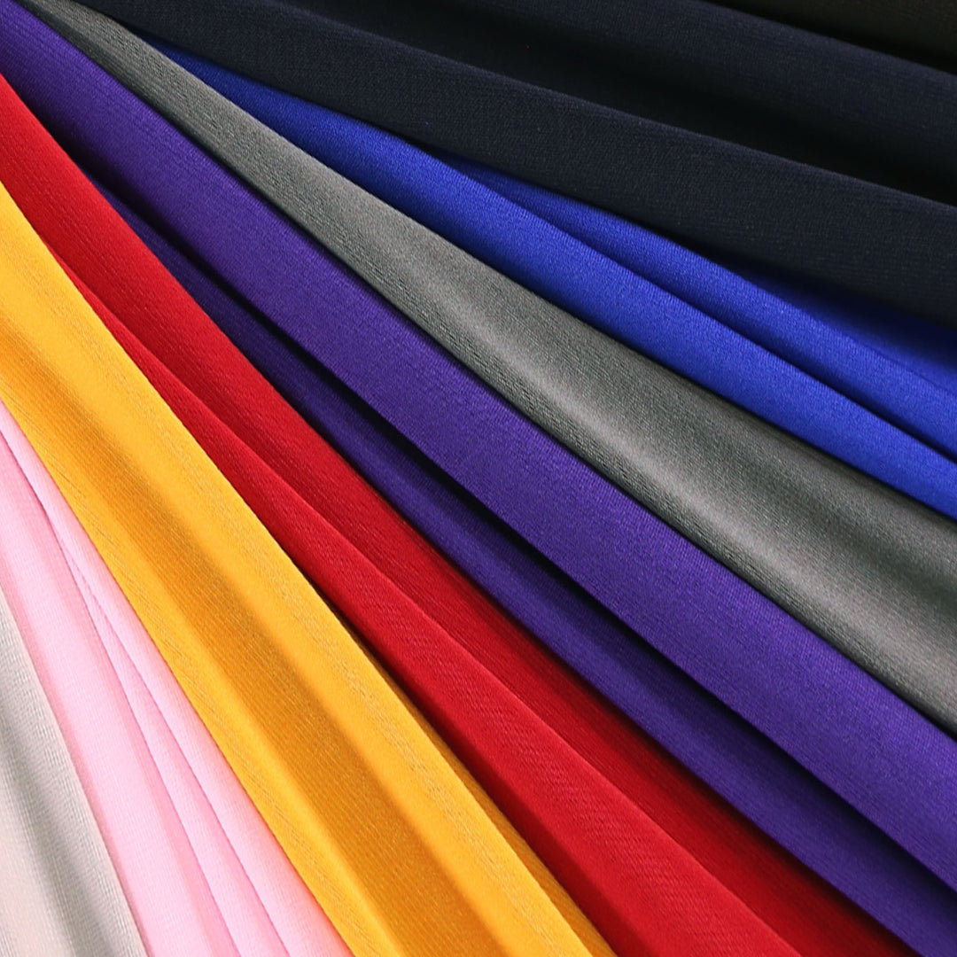Selection of ITY Knit Jersey Fabric swatches, displaying the fabric's unique drape and vibrant color variations ITY Polyester Spandex