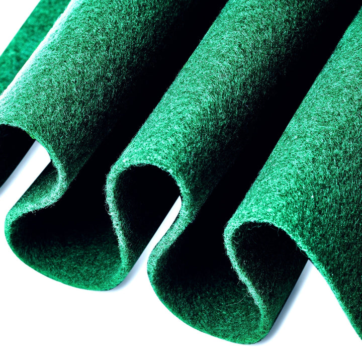 Green felt rolls on a white background