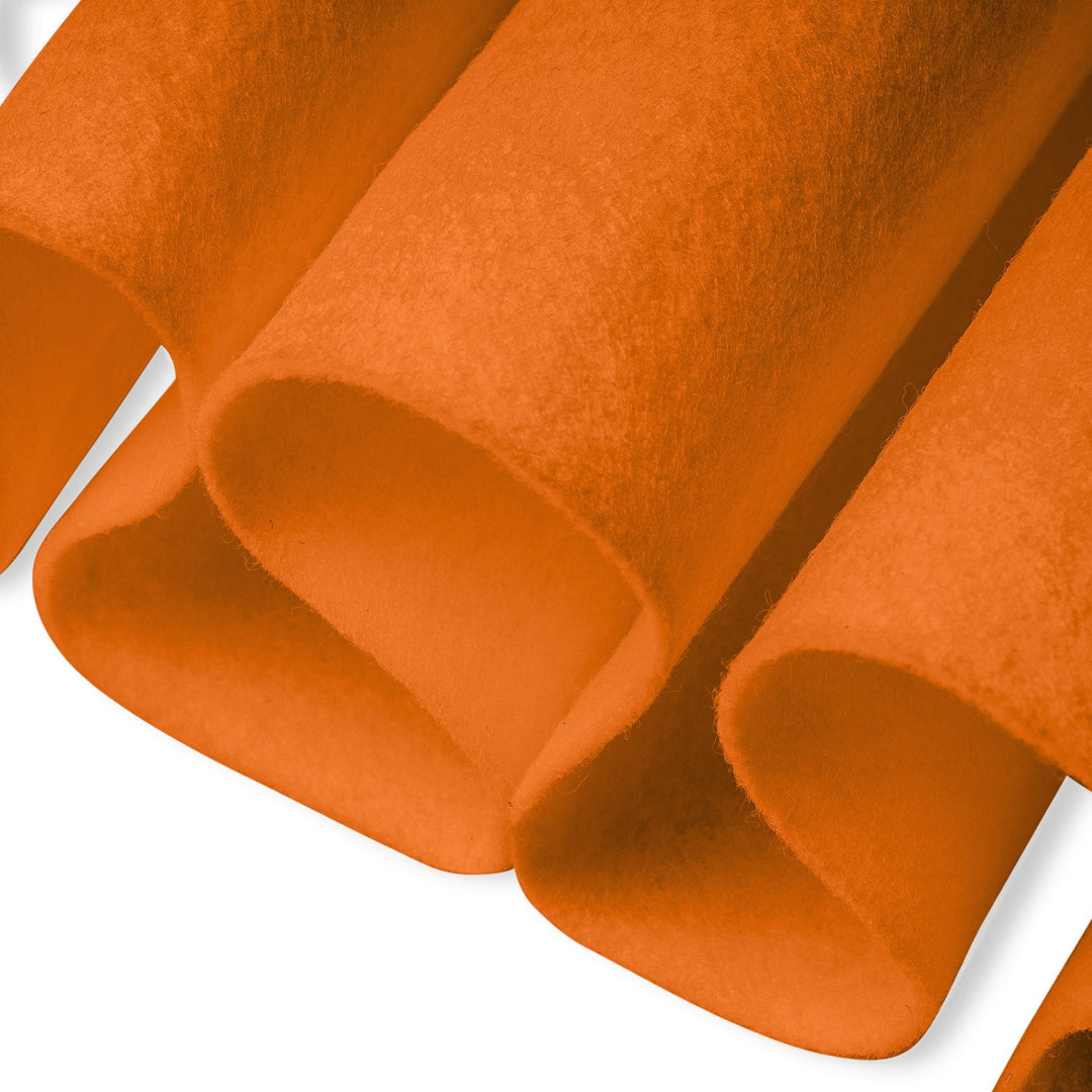 Close-up of orange felt fabric with a textured pattern on a white background