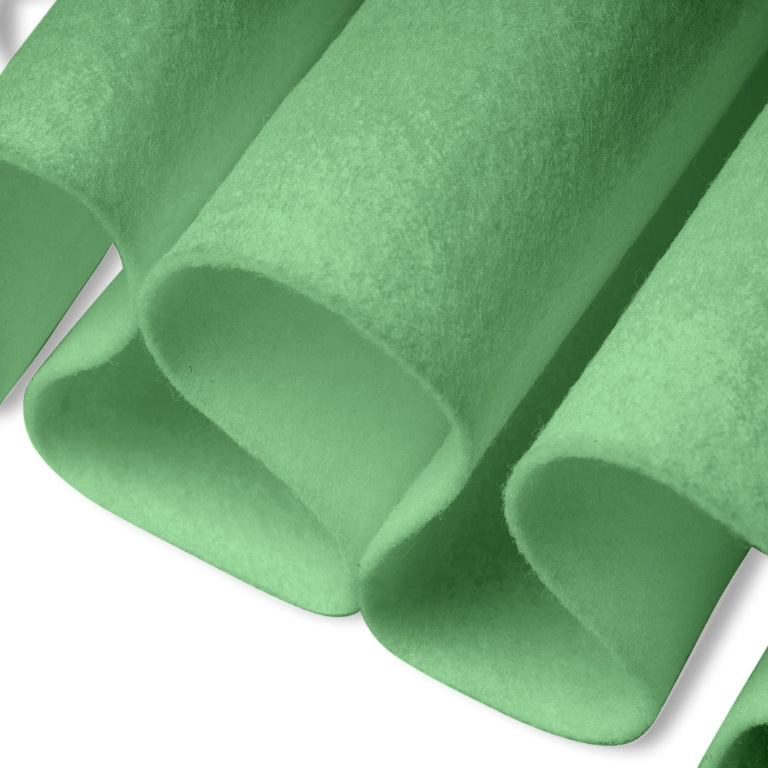 Close-up of green felt fabric with a soft texture on a white background