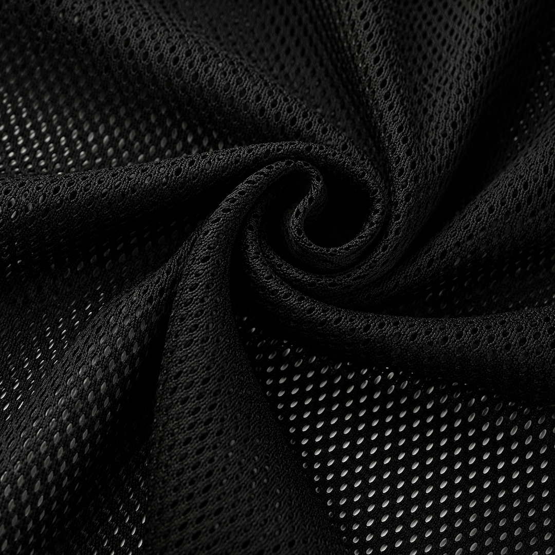 Black mesh fabric with a textured perforated pattern, shown draped in a spiral swirl to highlight its texture and flexibility.