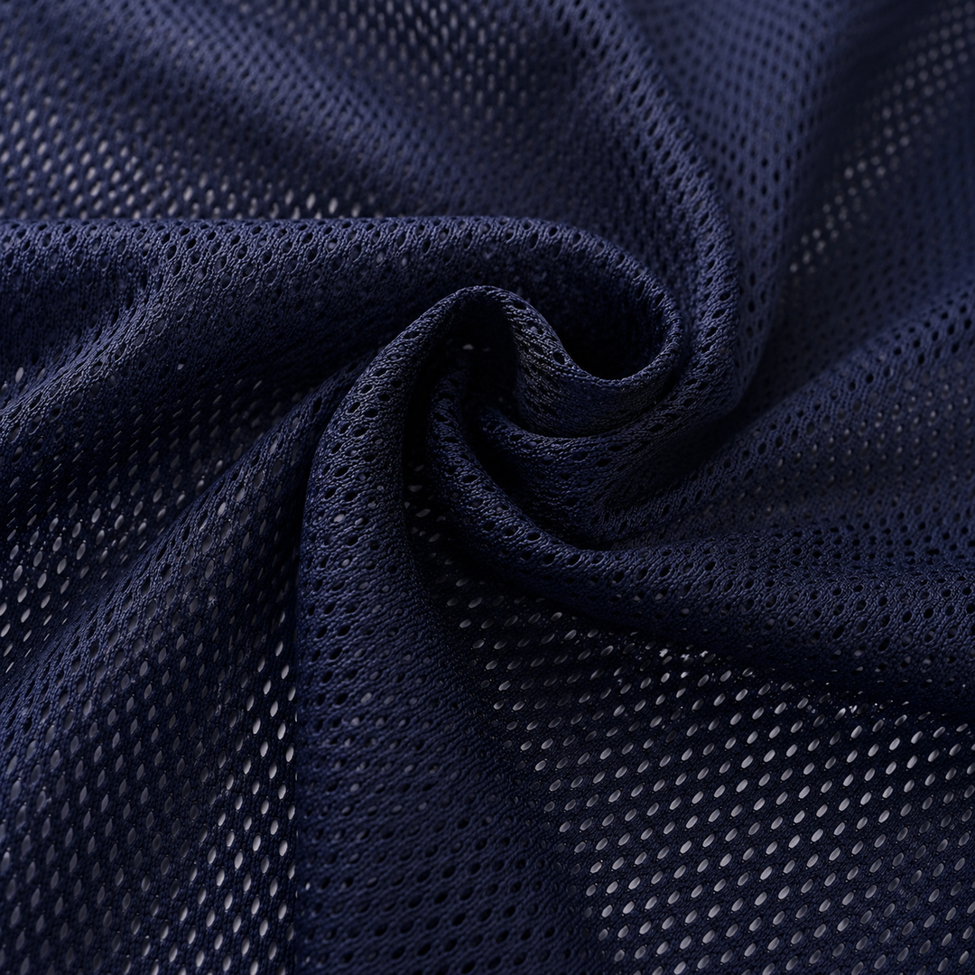 A close-up of dark navy blue athletic mesh fabric, swirled to show the texture and open-knit pattern.