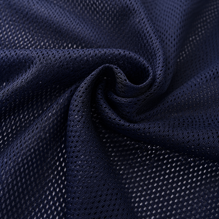 A close-up of dark navy blue athletic mesh fabric, swirled to show the texture and open-knit pattern.