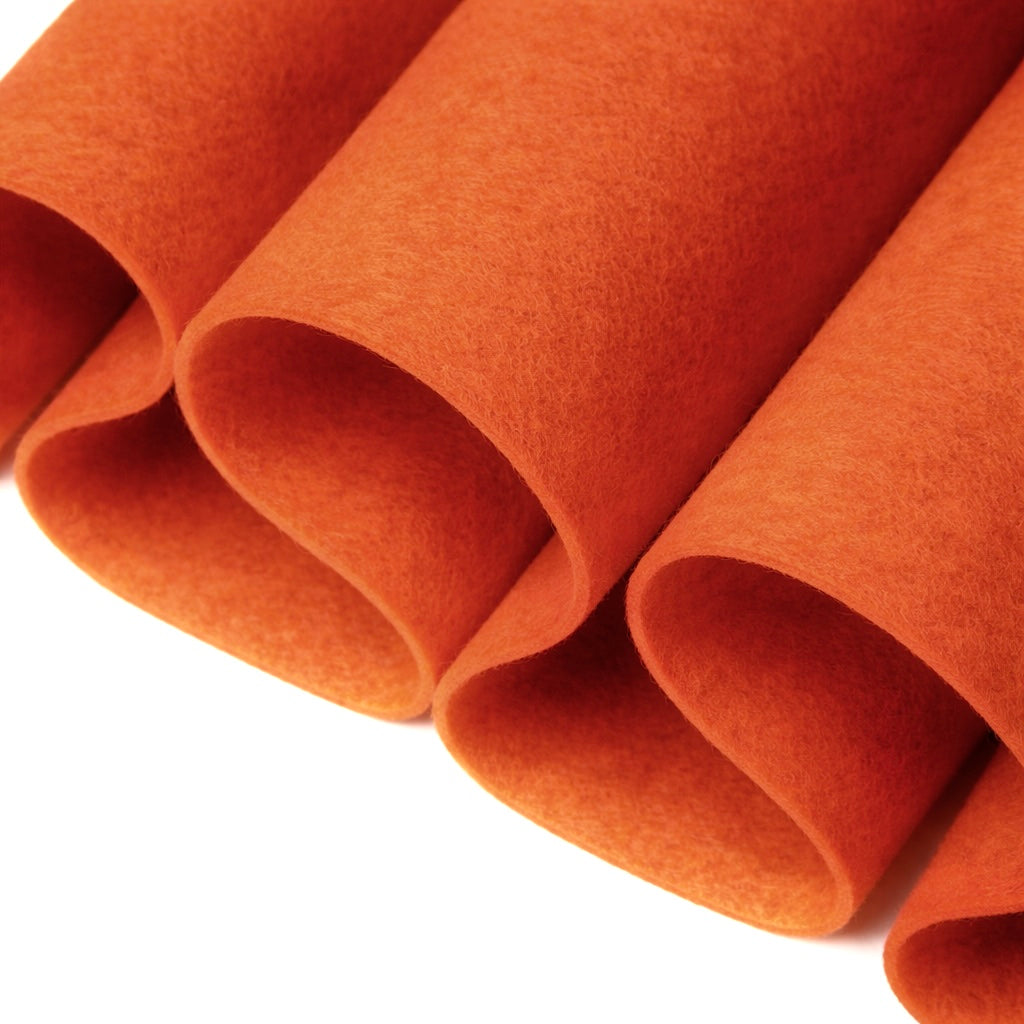 Crafting felt sheets in vibrant orange, showcasing the softness and texture for various DIY projects.