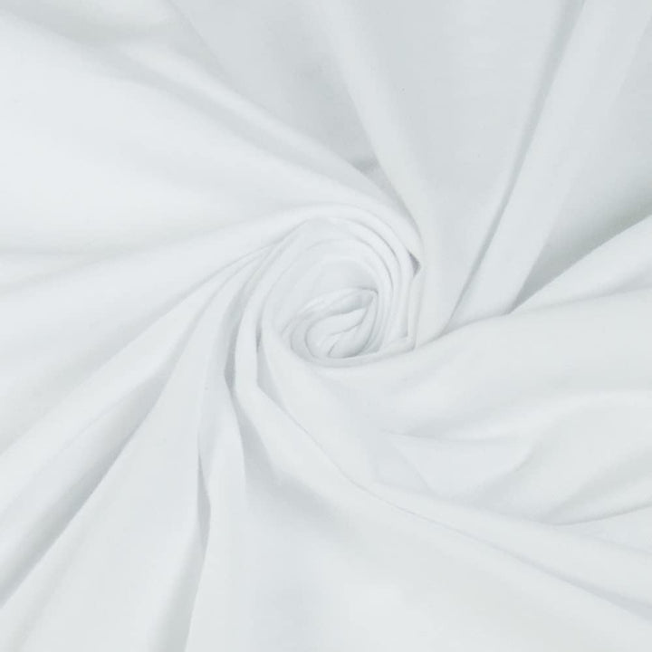 Close-up of white organic fabric with a subtle swirl pattern