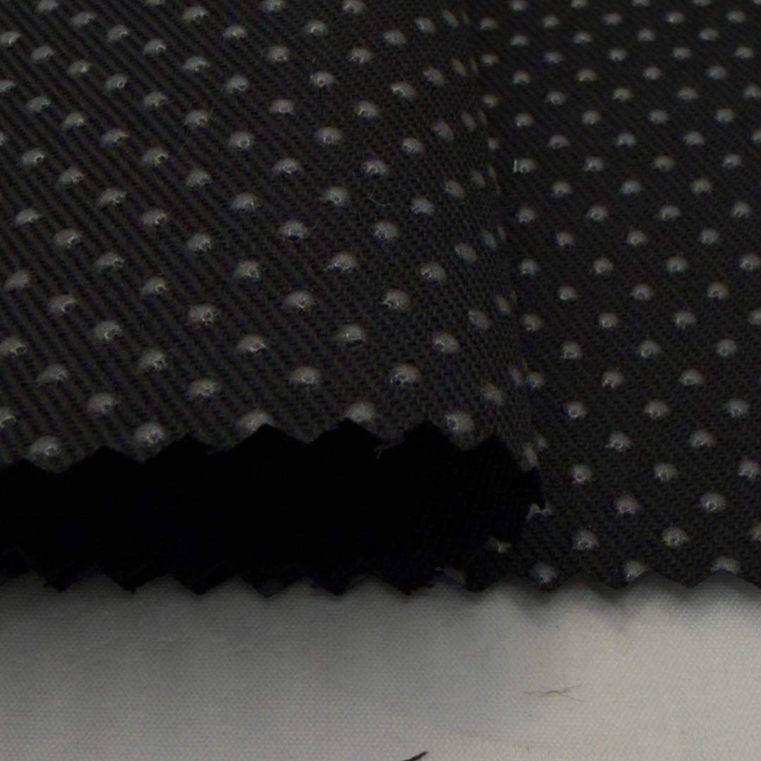 Black silicone dot anti-slip fabric with textured surface, ideal for sewing projects. Non slip fabric for reliable grip and stability.