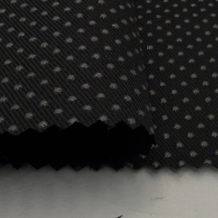 Black silicone dot anti-slip fabric with textured surface, ideal for sewing projects. Non slip fabric for reliable grip and stability.