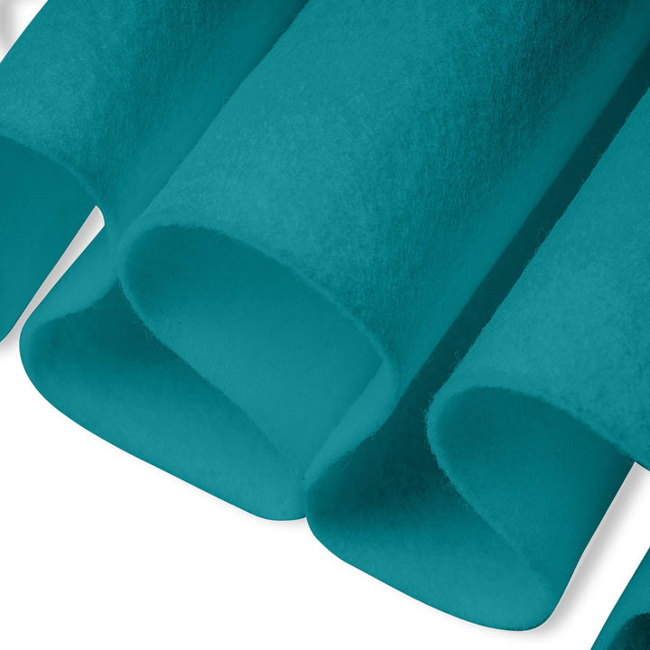 Close-up of teal fabric with a soft texture on a white background