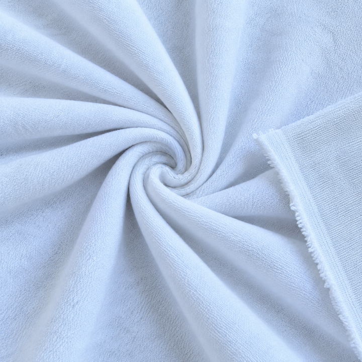 Close-up of loop terry fabric in white, showcasing soft and plush texture, ideal for sewing and crafting projects.