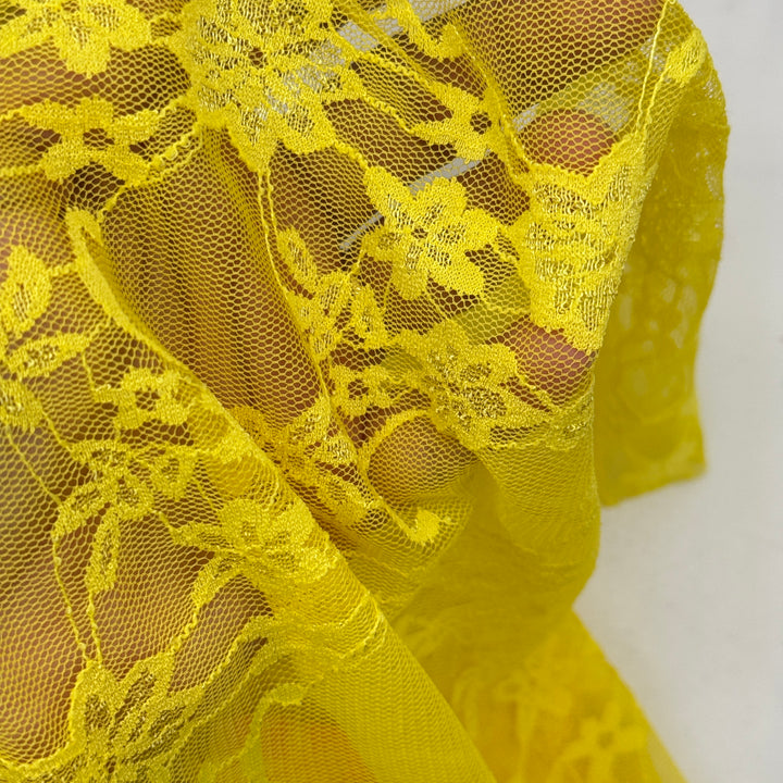 Close-up of yellow lace fabric on a white background